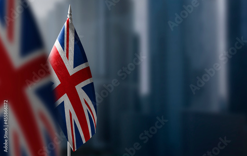 Small flags of United Kingdom on a blurry background of the city