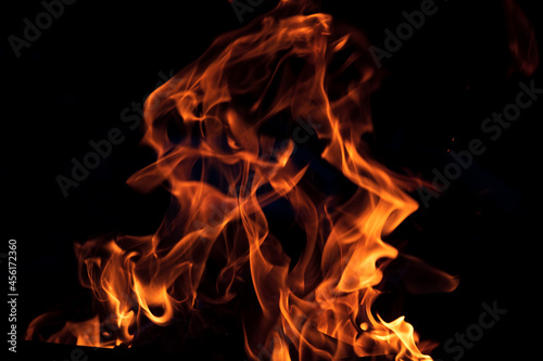 Orange flame on black background. Heat energy heap closely, red and yellow