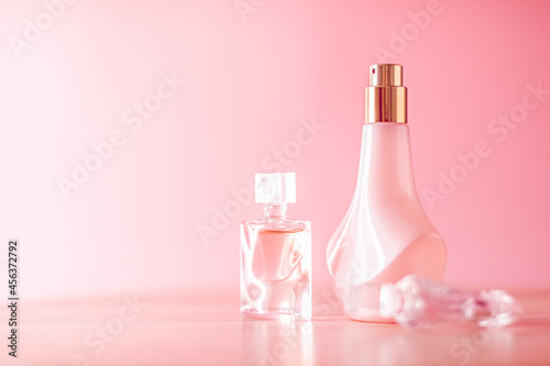 Luxury set of organic perfumes on pink background.