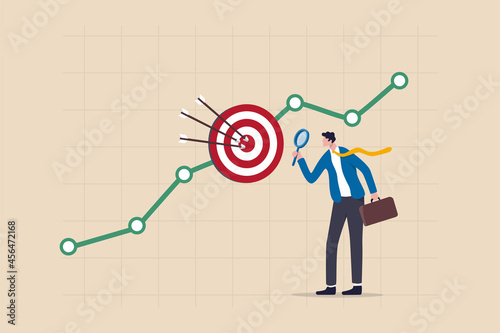 Marketing target audience research, business analysis to increase sale, target group or focused customer concept, businessman marketer holding magnifying glass analyze customer data graph and chart.