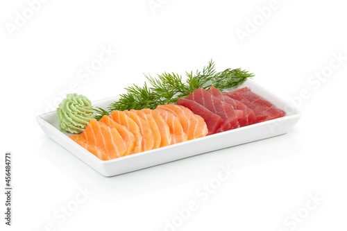 Tuna and salmon tataki plate on white background. Slices of tuna and fresh salmon with wasabi. Asian food