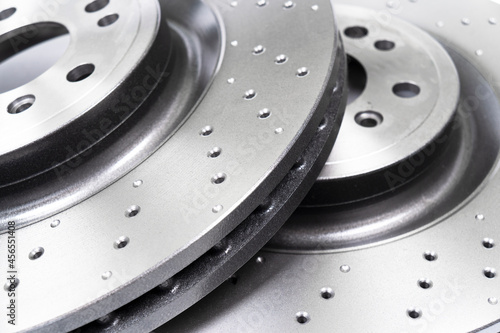 Two car brake disc background texture. Auto spare parts. Perforated brake disc rotor. Braking ventilated discs. Quality spare parts for car service or maintenance