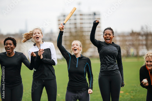 Female rounders team cheering at rounders match