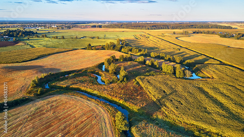 September agriculture fields aerial panorama. Sunny autumn landscape. Meadows, river, village