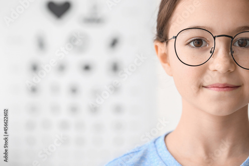 Little girl wearing new eyeglasses at ophthalmologist's office