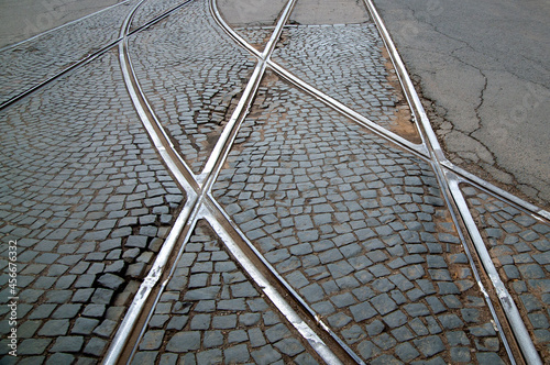 abstract background with tram rails on paving stones and asphalt