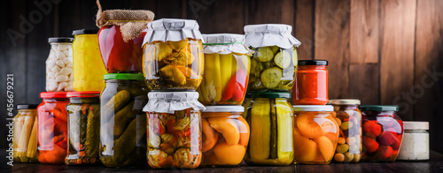 Jars with variety of marinated vegetables and fruits