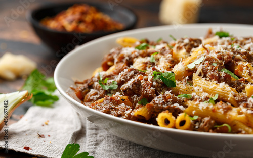 Pasta alla Genovese on a white bowl with parmesan cheese. Traditional neapolitan food.