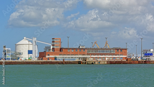 Dock and quays with terminal building and industrial silo`s in the harbor of Calais, France 