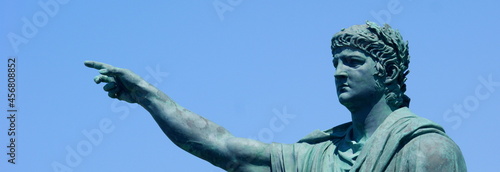 Anzio - Italy, 29 July 2011: statue of Nero created by the sculptor Claudio Valenti inaugurated in 2010 on the waterfront of Anzio, with trees and blue sky in the background. BANNER, copy space