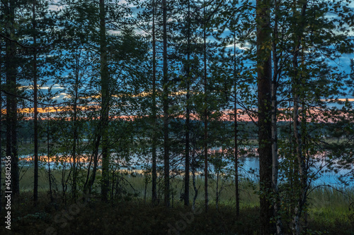 Night over the lake. Sunset. Blue sky. Red sunset. Night in the woods. Northern landscape.