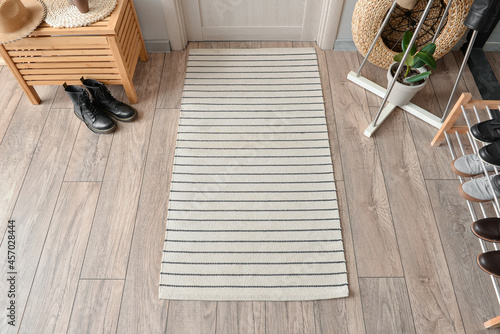 Stylish rug on floor in interior of modern hallway