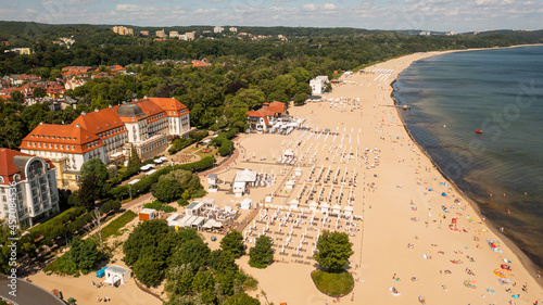 Sopot,Poland,Europe.Aerial photo from drone to the beach Sopot, wooden pier (molo) resort old lighthouse, with marina, yachts, infrastructure, park, promenade and Sofitel Grand Sopot Hotel