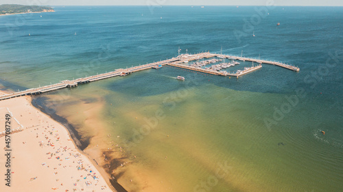 Sopot,Poland,Europe. Beautiful panoramic aerial photo from drone to Wooden pier (molo) with promenade marina, yachts, beach, Sopot.(Series)