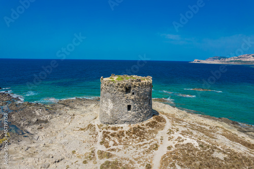 Aerial view of nuraghe in a island in Stintino, La Pelosa beach in Mediterranean sea. The nuraghe or also nurhag in English, is the main type of ancient megalithic edifice found in Sardinia.