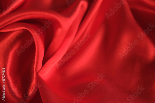 abstract texture of draped red velvet background. eautiful textile backdrop. Close-up. Top view