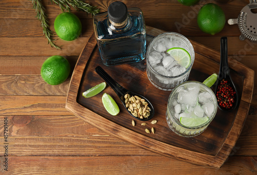 Glasses of cold gin and tonic on wooden background