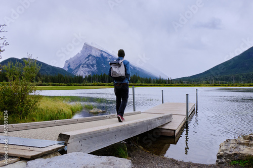 Pier on Vermillion lake with man and in the background mountain Rundle 1, Banff National Park