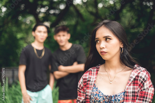 A young woman walking by herself is worried about two rude men catcalling and from behind. Possible stalkers following her. Street harassment.