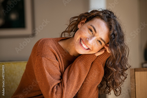 Young woman laughing while relaxing at home