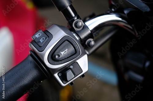 The handlebar switch on the left side of the motorcycle.