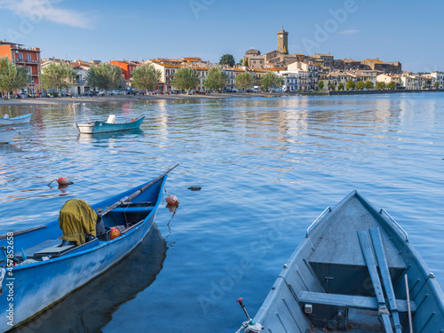 view through boats to city Marta on lake Bolsena in Italy