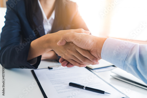 two business person shaking hands after deal contract done.