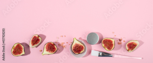 Wide banner with fresh fig fruits in a raw on pink background.