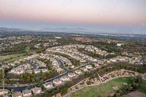 Aerial view of a gorgeous southern California sunset from an upscale neighborhood on a golf course. 