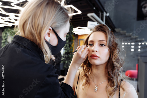 Applying makeup on the eyebrows in a beauty salon.