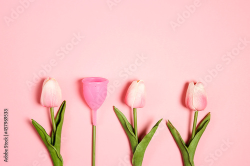 Tulips with menstrual cup as a flower on pink background. Eco-friendly reusable silicone, ecological alternative, zero waste concept.