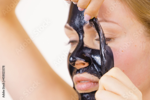 Girl removes black mask from face