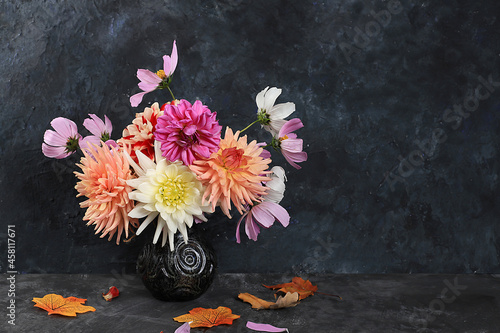Dahlias and daisies in a vase on a dark old grunge background.Autumn abstract composition, Thanksgiving day concept, seasonal background, banner or splash, greeting card or invitation