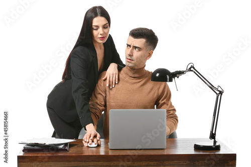 Beautiful young secretary seducing her boss on white background. Concept of harassment