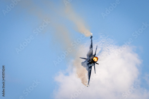 Fighter jet displaying during airshow with afterburner