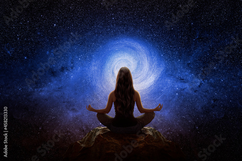 Woman with yoga pose in front of the universe