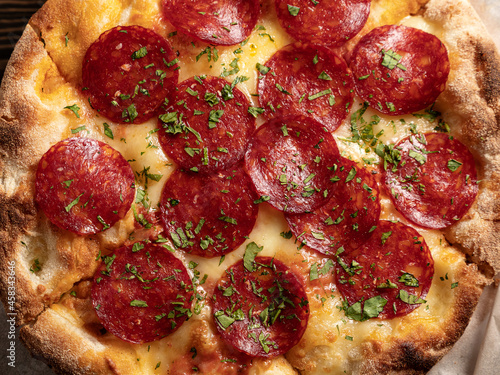 Fresh baked traditional italian pizza Alla Diavola with pepperoni and hot salami
