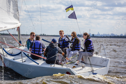 Team athletes participating in the sailing competition.Sailing Crew in Action.Young people enjoying on the yacht