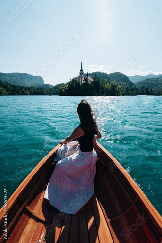 A woman on a boat riding towards the island of Bled, Slovenia