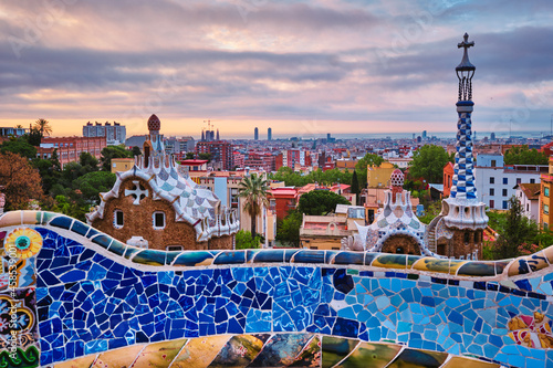 Barcelona city view from Guell Park. Sunrise view of colorful mosaic building in Park Guell