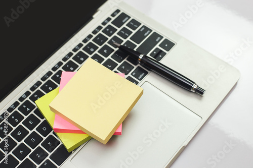 Stack empty sticky post note paper sheet on laptop keyboard. note list, message memory.