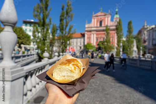 eating traditional slovenian strukelj roll in Ljubljana