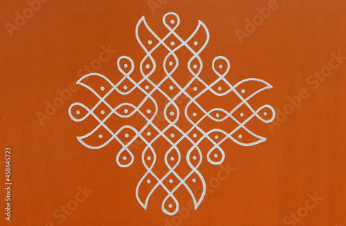 Indian Hindu traditional rangoli drawing on the wall of rural house