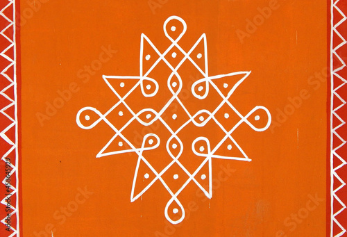 Indian Hindu traditional rangoli drawing on the wall of rural house