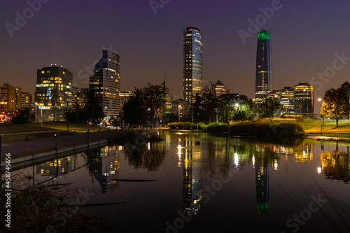 Night view to skyscrapers of Santiago de Chile reflected in the water