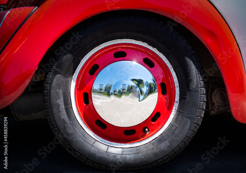 Close up of a car wheel with chrome hubcap