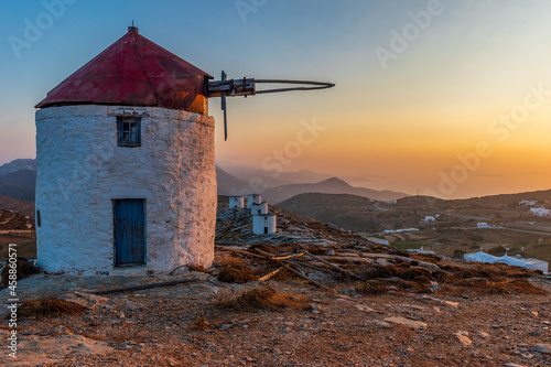 scenic golden hour view of a traditional wind mill in Chora Amorgos Greece