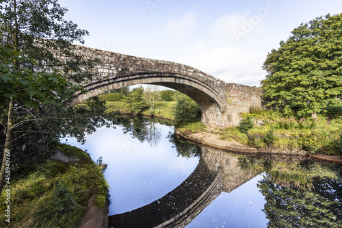 Old Lanercost Bridge built of red sandstone over the River Irthing in 1724 at Lanercost, Cumbria UK