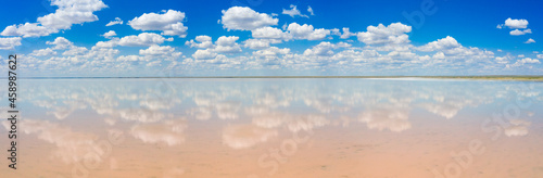 amazing panorama of Lake Elton on a summer day, beautiful sky with clouds and its reflection in the water