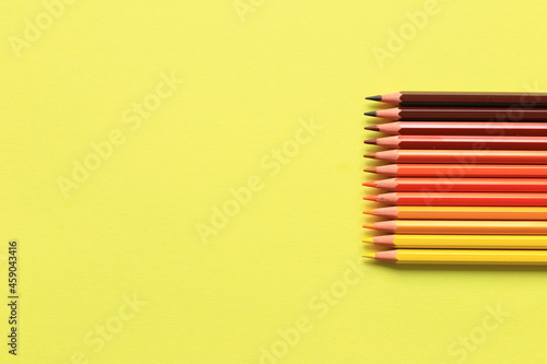 Colored pencils on a colored background. A set of pencils for drawing. Background from pencils.